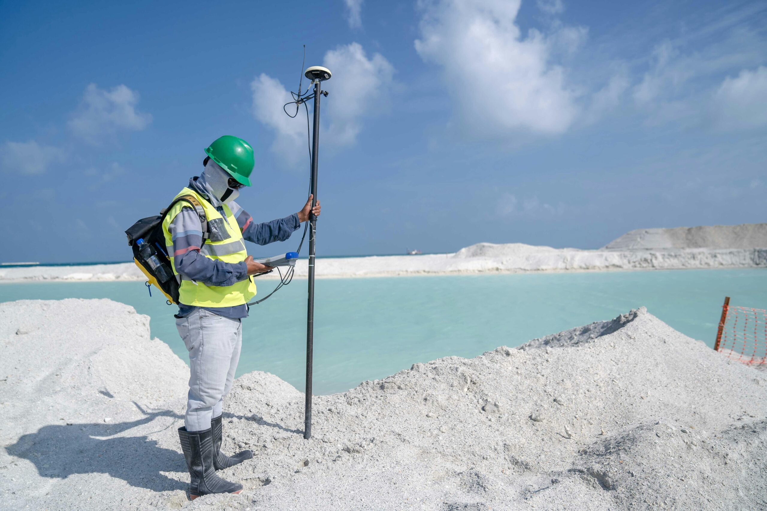 Man with Measurement Device by Lake