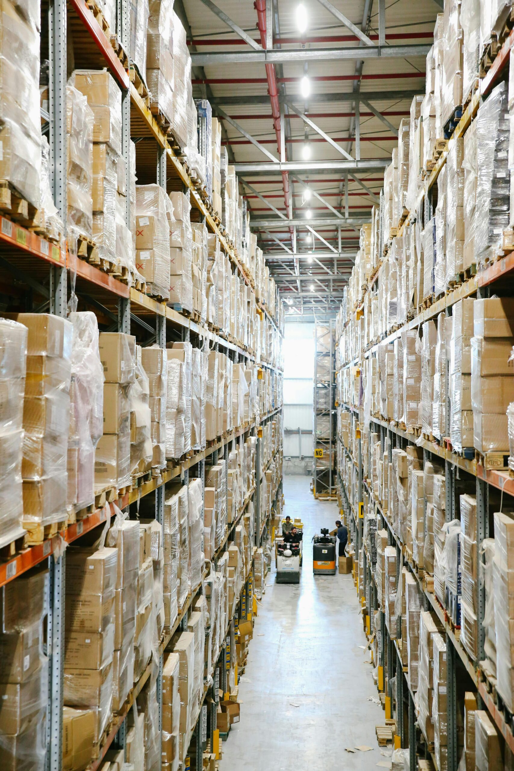 Spacious warehouse aisles lined with shelves stacked with boxes and packaging.